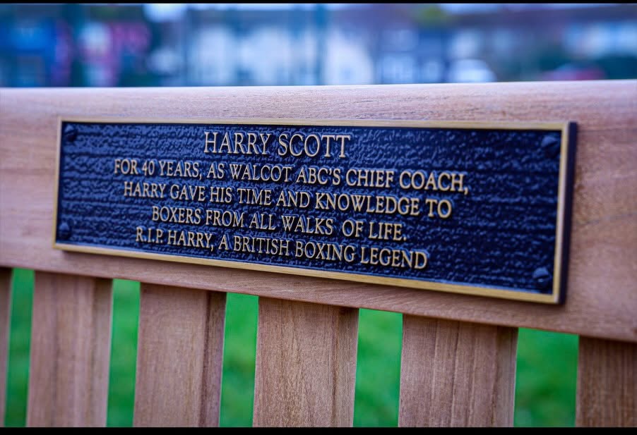 The plaque on a memorial bench for Harry Scott, stating:
"Harry Scott - For 40 years, as Walcot ABC's Chief Coach, Harry gave his time and knowledge to boxers from all walks of life. R.I.P Harry, a british boxing legend."